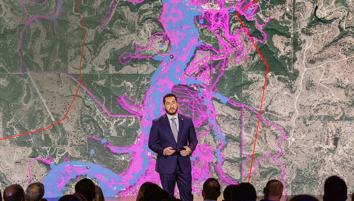 Analyst presenting interactive data visualisation on a large screen